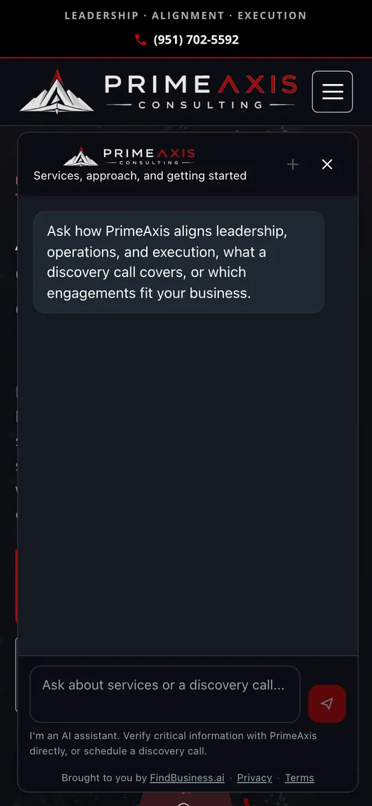 PrimeAxis Consulting's website on a phone with its AI agent open, in PrimeAxis's black and red, offering to explain their approach and the discovery call.
